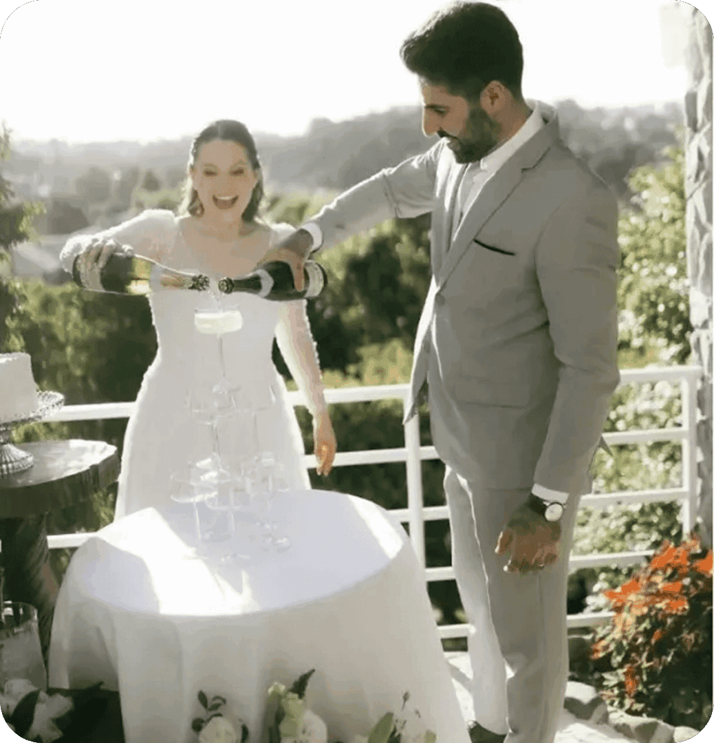 Bride and groom pouring champagne tower.